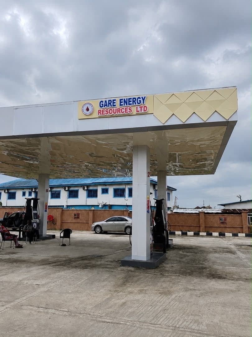 Fuel station canopy illuminated cleanly against an evening sky