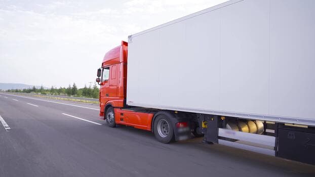 A clean industrial fuel delivery truck moving on a highway